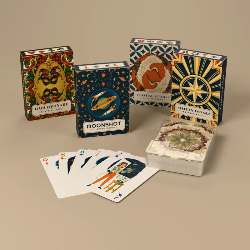 Moonshot, Harlequinade, Floating Seasons and Maiden Voyage decks in their tuck boxes, a Herbarium Nostalgia Instant deck in its clear case, and a fan of Moonshot cards