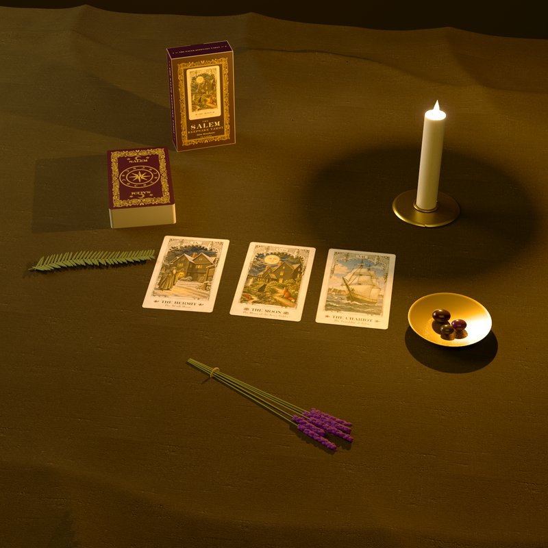 The Hermit, The Moon and The Chariot laid out by candlelight, with the box and the deck