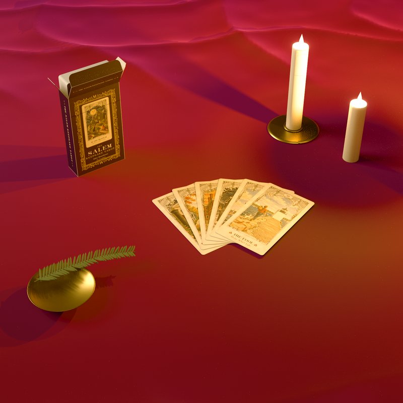 The open box and six cards fanned on red velvet, beside two candles